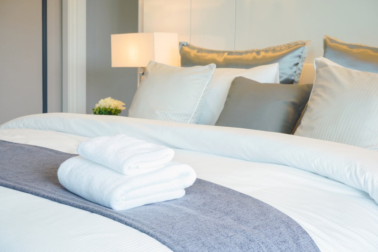 Clean towel on bed in modern interior bedroom