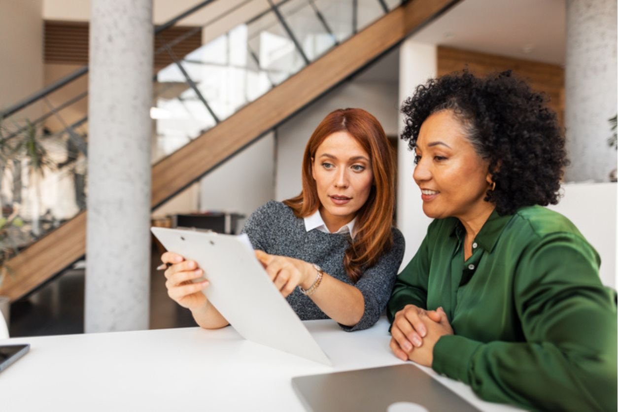 Research coordinator reviewing clinical trial information with a participant considering involvement in a myasthenia gravis research study.